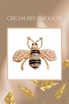 Gold and clear rhinestone striped bee brooch pin featuring cream pearl detailing. Pin closure. Bee measures are 1.65 inches long. PERFECT GIFTS!!! BEAUTIFULLY DETAILED, WONDERFUL QUALITY!!! Pearl Cream, Clear Rhinestones, Enamel Pins