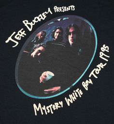 a black t - shirt with an image of the band's members on it