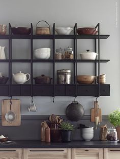 the shelves are filled with pots and pans