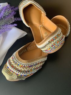 Traditional shoe/jutti Honeycomb . Made in Punjab, india. Entire shoe is made of genuine leather. For total comfort double cushion added. Leather lining to the side. Front and back has jari and head work. Completely hand made. Traditional Meenakari Slip-on Flats, Navratri Closed Toe Flats With Mirror Work, Handwork Leather Closed Toe Flats, Handwork Leather Closed-toe Flats, Leather Closed Toe Flats With Handwork, Traditional Flats With Mirror Work For Navratri, Leather Closed Toe Flats For Festivals, Festive Handwork Leather Flats, Handwork Leather Flats For Festivals