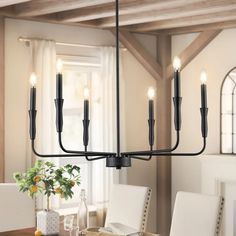 a chandelier hanging over a dining room table