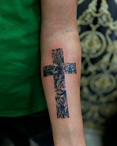 a person with a cross tattoo on their arm