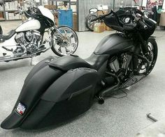 two motorcycles parked next to each other in a room