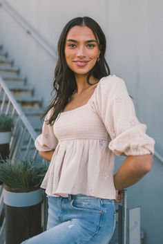 This sweet woven cotton gauze babydoll features a square neck with 3/4 sleeves and delicate flower embroidered detailing. Color: Almond Smocking Hand wash cold Spring Feminine Peasant Top With Smocked Cuffs, Casual Floral Embroidered Square Neck Top, Casual Floral Embroidery Square Neck Top, Casual Square Neck Top With Floral Embroidery, Spring Feminine Peasant Top With Square Neck, Summer Peasant Top With Smocked Back And Square Neck, Summer Peasant Top With Square Neck And Smocked Back, Summer Square Neck Peasant Top With Smocked Back, Cotton Smocked Top For Spring Daywear