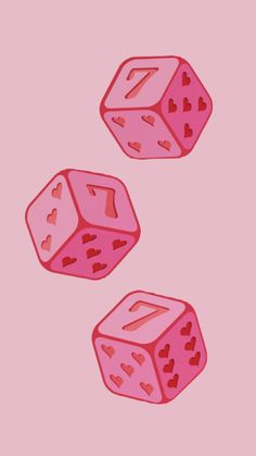 two pink dices with hearts on them sitting next to each other in front of a pink background