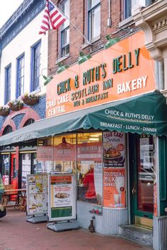 an orange and green awning on the side of a building that says chick & ruth's deli