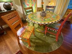 a table with chairs and a vase on top of it in a living room area