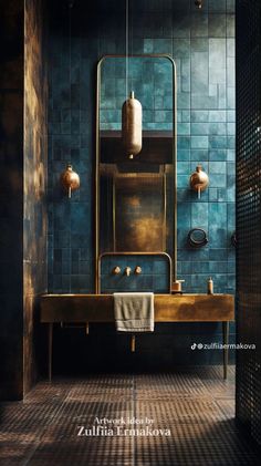 a bathroom with blue tiles and gold fixtures