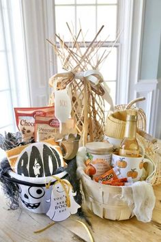 a wooden table topped with a basket filled with lots of different types of food and snacks