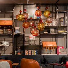 a living room filled with furniture and hanging lights