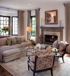 a living room filled with furniture and a fire place in the middle of it's walls