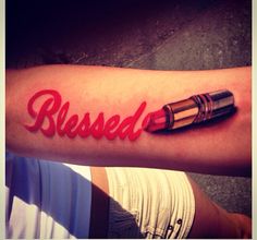 a person with a red ink tattoo on their arm that says,'blessed '