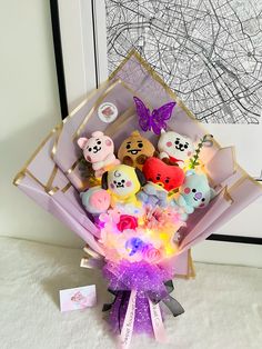 a bunch of stuffed animals sitting in a basket on the floor next to a wall