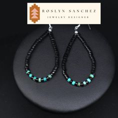 This is a pair of natural jet and turquoise heishi earrings. These earrings match a lot of our jet necklaces but are also great on their own.  A very soft material, Acoma jet is the most commonly found jet in Native American jewelry in the Southwest. It holds many of the same properties as that of jets from other origins, however it often times can show more characteristics of the wood it formed from. *2 3/4" X 1" which includes the earring hooks *natural jet heishi & turquoise heishi *sterling silver hooks A Living Stone All Native Americans believe that the earth is living and all things are precious. Turquoise is no exception, representing life, and is highly revered because of its color-changing properties. Factors such as the environment, light, dust, and skin acidity all play a role Black Southwestern Dangle Earrings, Southwestern Black Beaded Dangle Earrings, Artisan Black Jewelry With Ear Wire, Southwestern Style Black Beads Jewelry For Gift, Southwestern Style Black Bead Jewelry For Gifts, Southwestern Style Jewelry With Black Beads For Gift, Adjustable Southwestern Black Earrings, Southwestern Black Beaded Earrings For Gift, Southwestern Black Sterling Silver Jewelry