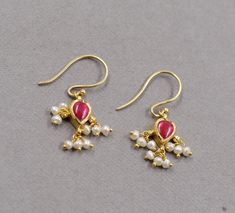 Earring 22K gold ruby slices & pearl beads charms jewellery hook earring handmade  pink ruby stone we can coustomizethis for you Kundan-setting for gemstones is the traditional Indian style of settings. It is a unique technique that is traditional to Rajasthan and mainly practiced in Jaipur and Bikaner provinces. The process cannot be replicated with machines and is completed by three different, highly skilled craftsmen. It takes them years of dedication to learn this art. Though this style of jewelry is mainly made as ornate Indian bridal jewelry, we have tried to make this art form more modern. Women can wear these stylish earrings to dress up for the office or out for a special evening. Comes in a nice jewelry box, perfect for gifting. Product Description  Gross Weight : 2.020 Gms  Gold 22k Gold Pearl Earrings For Festivals, 22k Gold Pearl Earrings As Festival Gift, 22k Gold Pearl Earrings For Gift During Festivals, Festive Pink Jewelry With Ear Wire, Traditional Pink Jewelry With Ear Wire, Yellow Gold Pearl Drop Danglers For Gift, Yellow Gold Danglers With Pearl Drop For Gift, Jewelry Hooks, Pink Ruby