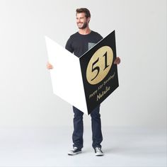 a man is holding up a sign that says 25