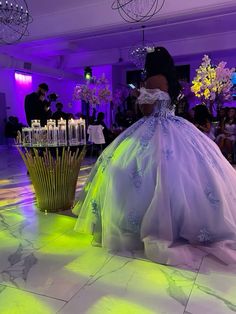 a woman in a ball gown on the dance floor