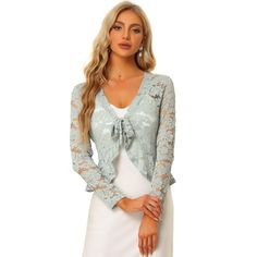 Opt for a decadent cover-up for your special occasions with this lace shrug. This stretchy lace cardigan offers the perfect balance to longer layers in a waist-defining cut with a tie front. Constructed in a classic shrug silhouette, this charming piece benefits from an open neck and elegant long sleeves with ruffles. Intricate design details include a satin binding around the front and hem and a floral lace design. Paired with a sleeveless dress, spaghetti strap, tank top, or simple off-shoulde Cropped Shrug, Lace Shrug, Bolero Cardigan, Lace Bolero, Rib Knit Cardigan, Long Sleeve Knitted Cardigan, Women's Tie, Tie Front Top, Lace Cardigan