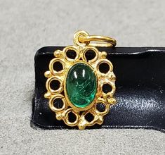 1. Emerald 18k Gold Pendant 2. Zambian Emerald  3. Gemstone - Zambian Emerald  4. Jewelry Type - Pendant 5. Total Weight -  0.830 Gram Approx. 6. Emerald Weight - 0.50 Carats                 7. Gold Weight - 0.730 Grams Approx. 8. Gold Purity - 18k 9. Pendant Bails Outer Size - 6 MM 10. Emerald Size - 4 x 6 MM 11. Stone Shape - Oval  12. Floral designs 13. Ready to dispatch in 1 - 2 days. 14. Handmade Items 15. AAA Quality Pendant 16. 1 Quantity Available  17. Handmade Accessories  Pictures are Classic Gold Gemstone Cabochons, Gold Round Cabochons With Bezel Setting, Gold Elegant Cabochons With Bezel Setting, Elegant Gold Cabochons With Bezel Setting, Gold Gemstone Cabochons For Anniversary, Gold Round Cabochons For Gift, Vintage Oval Gold Cabochons, Classic Gold Cabochons For Gifts, Accessories Pictures