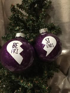 two purple christmas ornaments with white arrows on them