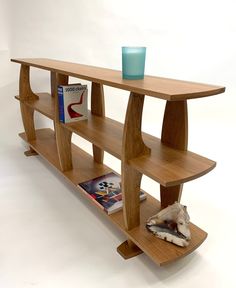 a book shelf with books and a vase on it