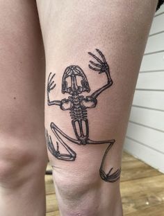 a woman's legs with a skeleton tattoo on it