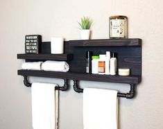 two wooden shelves holding towels and other bathroom items