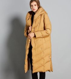 This down coat make with 90% duck down ,very warm in the winter .also could be custom made for any size. This is a winter down jacket fill with down.we design it with a very thick and warm style.this hooded down jacket could keep you very warm in the cold winter.the side pockets is very useful.a unique design women winter coat. Material: 90% duck down ,polyester Style: Casual Package Contents: 1 x down coat Size M:Length:110cm chest:110cm shoulder:40cm sleeve:59cm L:Length:110cm chest:114cm shou Duck Down Outerwear With Detachable Hood For Fall, Long Duck Down Coat For Fall, Duck Down Long Coat For Fall, Fall Duck Down Outerwear With Pockets, Solid Down Parka For Winter, Winter Down Outerwear, Long Duck Down Puffer Coat, Duck Down Parka For Cold Weather In Fall, Long Sleeve Duck Down Outerwear