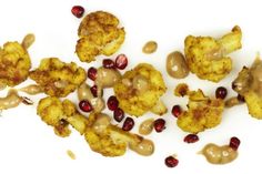 cauliflower florets with pomegranate and seeds on a white background