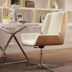 a white office chair sitting on top of a hard wood floor next to a desk