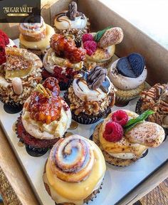 a box filled with lots of different types of cupcakes