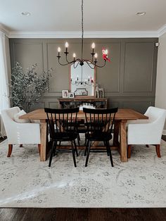 a dining room table with chairs and a chandelier