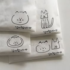 three napkins with cats drawn on them