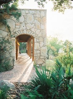 a stone building with an archway leading into it