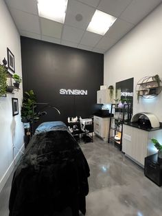 a salon with black and white furniture and plants