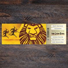 the lion king movie ticket sitting on top of a wooden table