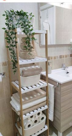 a bathroom with a wooden shelf holding towels and baskets