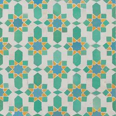 an artistic tile design in green, yellow and blue colors on a white wall or floor