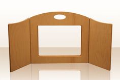 an open wooden display case on a white surface with no one around it or in the photo