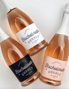 three bottles of rose wine sitting next to each other