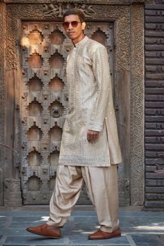 Beige straight kurta featuring chikankari embroidery with mirror detailing. Paired with a solid salwar. - Aza Fashions Navratri Kurta With Naqshi In Traditional Drape, Traditional Drape Kurta With Mirror Work In Jamawar, Traditional Chanderi Kurta With Naqshi, Raw Silk Traditional Wear With Mirror Work For Ceremonies, Traditional Cotton Silk Sherwani With Naqshi, Traditional Naqshi Kurta For Navratri, Navratri Chanderi Traditional Wear With Naqshi, Festive Cotton Silk Sherwani With Naqshi Detailing, Traditional Wear With Naqshi On Cotton Silk