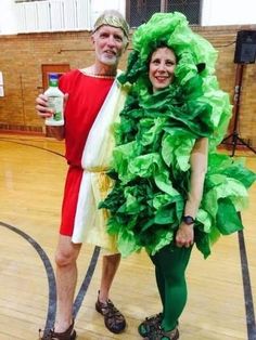 a man and woman dressed up in costumes standing next to each other on a basketball court