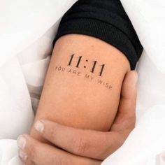 someone is holding their arm with the word 11 11 on it, which reads you are my wish