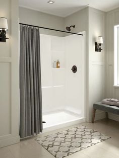 a bath room with a shower and a rug