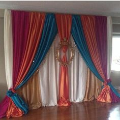 an image of a stage set up for a wedding ceremony with colorful drapes and curtains