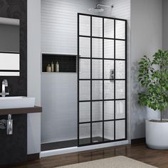 a bathroom with a toilet, sink and shower stall in the middle of the room