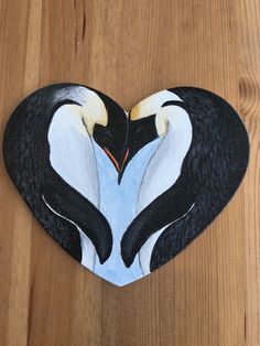 two penguins in the shape of a heart