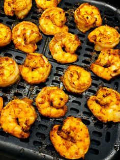 there are many shrimp on the grill and some is being grilled in it's own pan