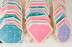 decorated cookies are arranged on a table with confetti and sprinkles