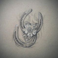 a drawing of a horseshoe with flowers on the side and an antelope's tail